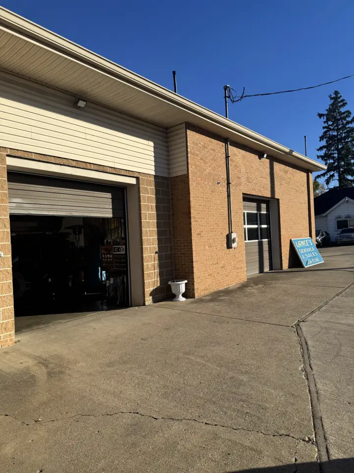 Outside Lance's Service & Sales at 6002 Taylor Mill Rd, with the bay door open and the shop sign out front
